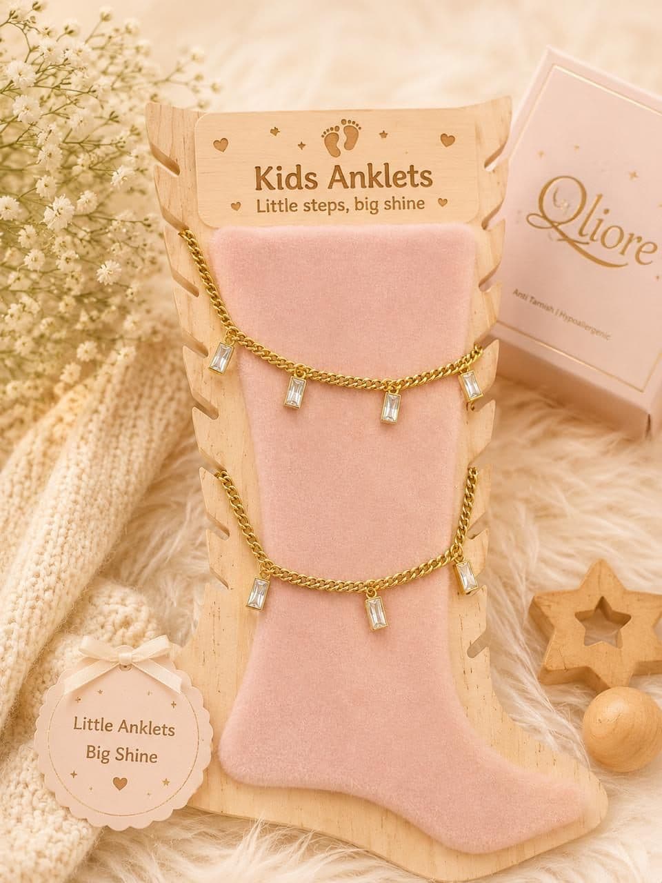 Two kids anklets on a velvet display